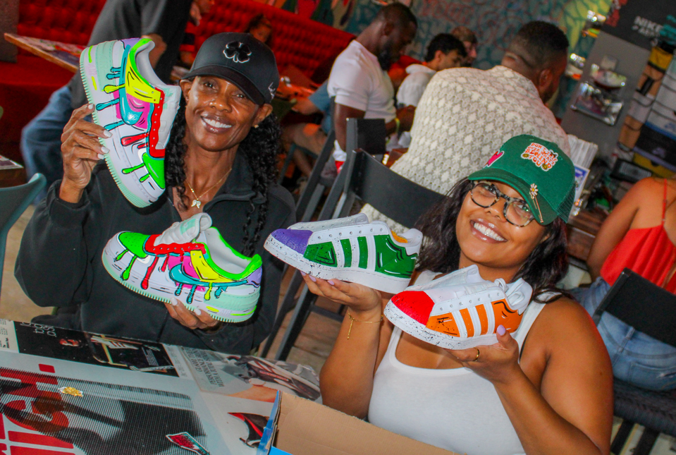 Guest painting a custom sneaker at Kick Art Workshop in Wynwood, Miami