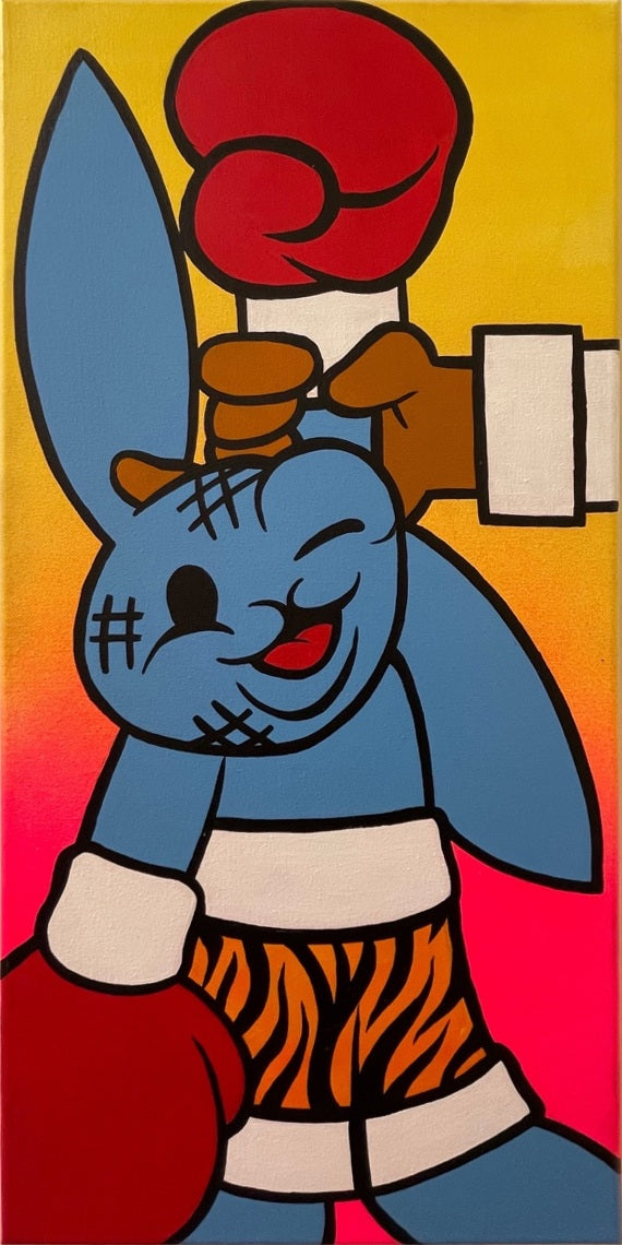 A blue rabbit raises a red boxing glove against a blazing yellow-to-pink background.