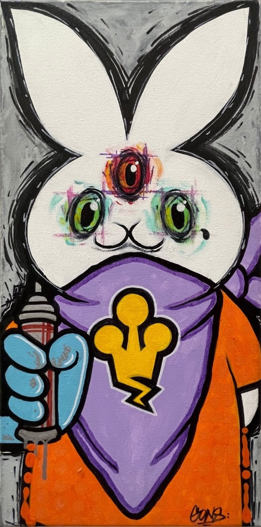 A white rabbit with three colorful eyes wears an orange shirt and a lavender bandana with a yellow crown motif.