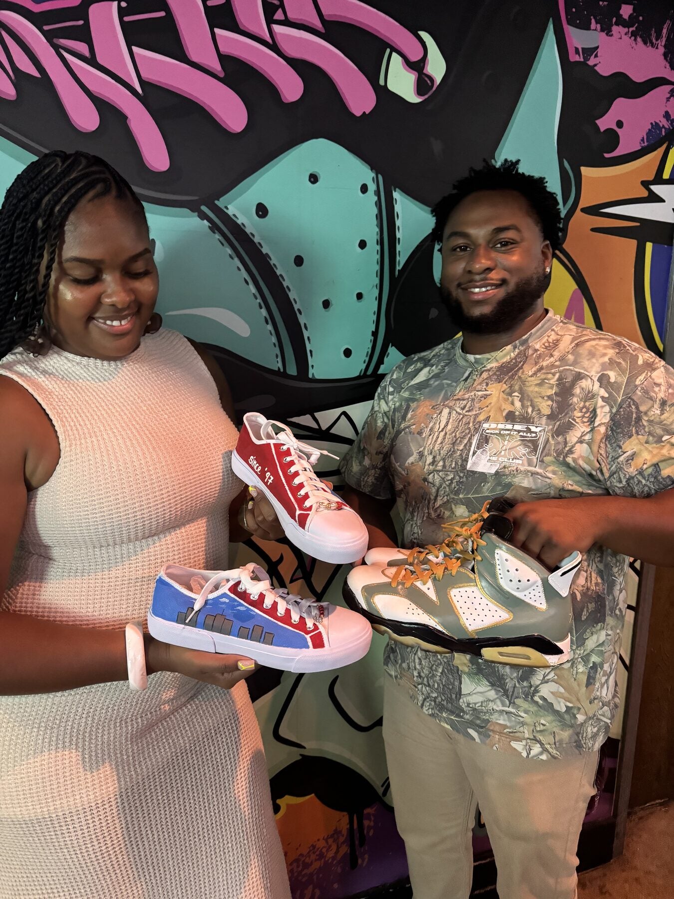 Friends posing with finished custom sneakers after a creative workshop in Wynwood Miami